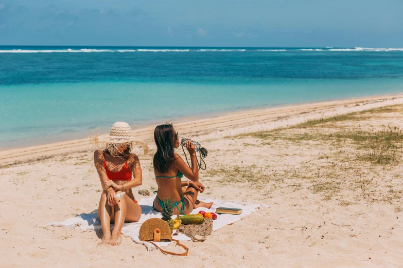 a couple of women sitting on top of a sandy beach, flatlay, on the beach at noonday, zac retz, moana