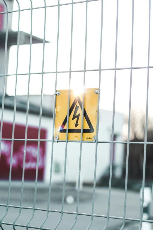 a close up of a sign on a fence, by Niko Henrichon, pexels, electrical plant location, square, portrait of dangerous, screensaver