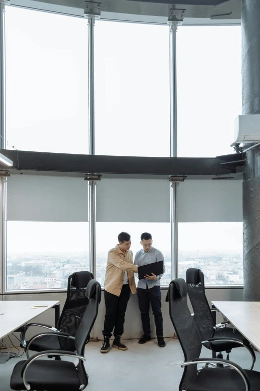 a couple of men standing next to each other in a room, by Jang Seung-eop, pexels contest winner, skybridge towers, in a meeting room, open top, jakarta