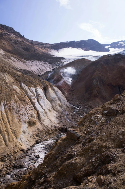 a group of people standing on top of a mountain, by Muggur, red narrow lava rivers, white steam on the side, ice and glaciers, gravel and scree ground