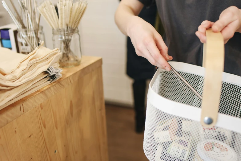 a person holding a wooden stick in a mesh basket, unsplash, at the counter, made from paper, rubbish, detailed product image