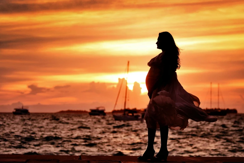 a woman standing on top of a pier next to a body of water, pexels contest winner, symbolism, pregnant belly, gorgeous romantic sunset, avatar image, profile picture