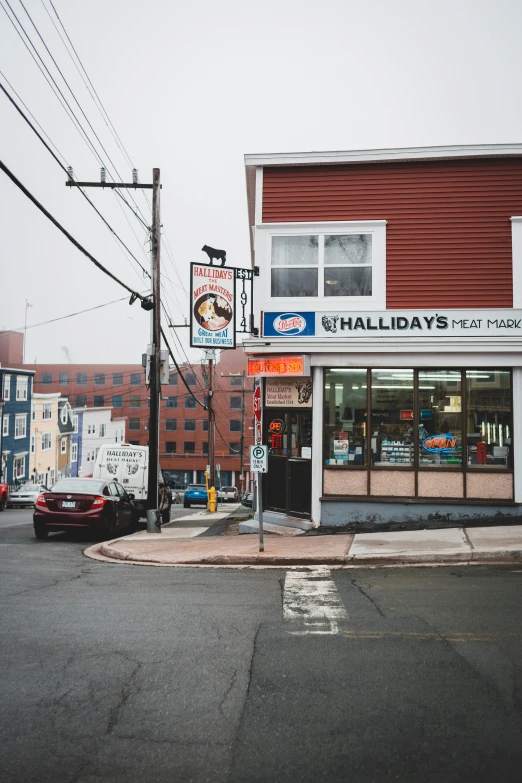 a red building sitting on the side of a road, by Chris Rallis, trending on unsplash, hotdogs, harbor, walrus, storefront