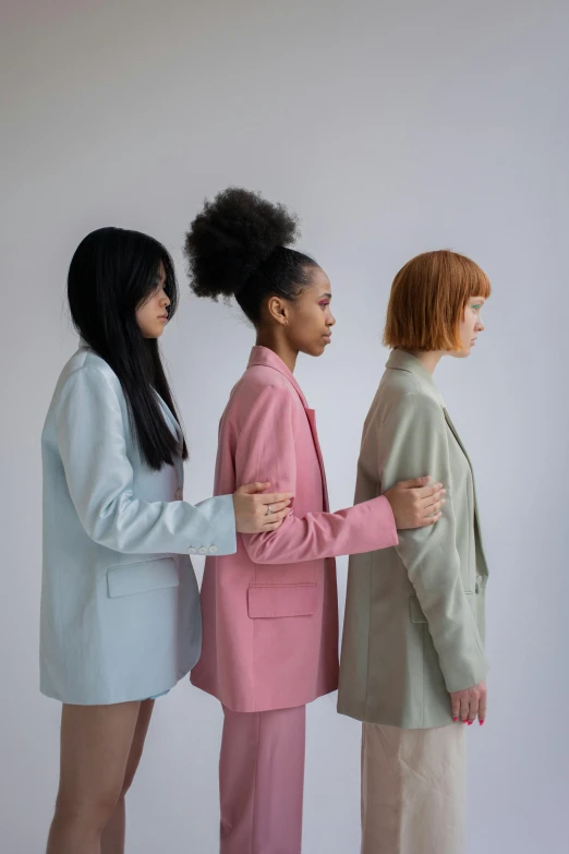 a group of three women standing next to each other, trending on unsplash, wearing a light blue suit, green and pink, fashion model features, faceless people