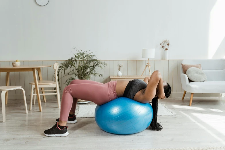 a woman is doing an exercise on an exercise ball, trending on pexels, figuration libre, half turned around, curved furniture, 🐎🍑, profile image