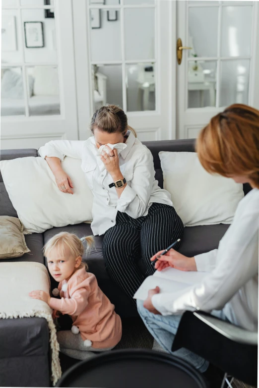 a woman sitting on top of a couch next to a little girl, sick with a cold, doctors office, crisp clean shapes, elegantly