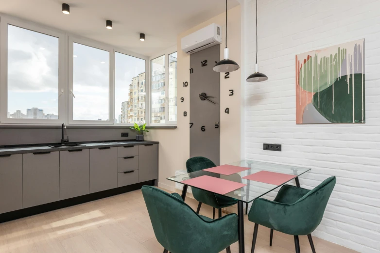 a dining room with a glass table and green chairs, by Adam Marczyński, city view, minimal kitchen, central hub, flat