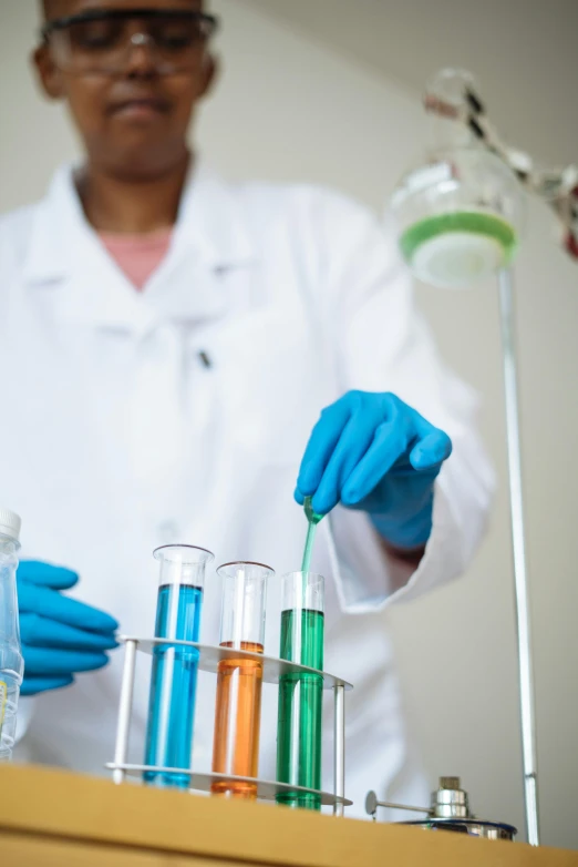 a person in a lab coat and blue gloves, a stock photo, shutterstock, analytical art, chartreuse and orange and cyan, photograph credit: ap, diversity, charts