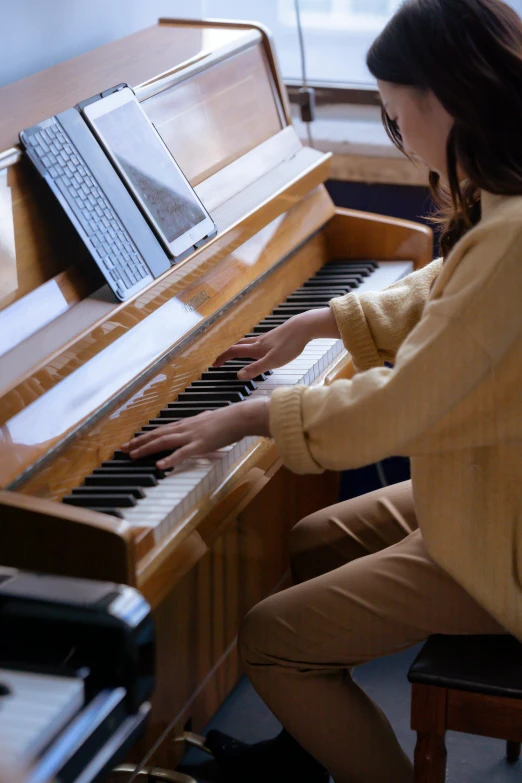 a woman sitting at a piano in a room, profile image, colour photograph, school class, full frame image