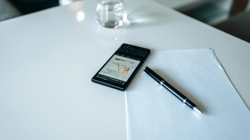 a cell phone sitting on top of a table next to a pen, analytical art, taken with sony alpha 9, avatar image, charts, medium-shot