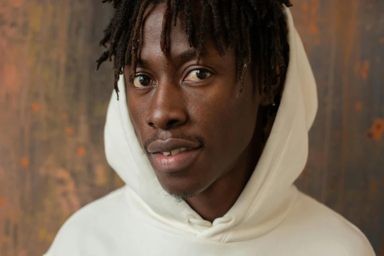 a man with dreadlocks wearing a white hoodie, inspired by Charles Martin, trending on pexels, hyperrealism, adut akech, mid length portrait photograph, frontal picture, thumbnail