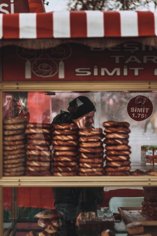 a display case filled with lots of donuts, by Tobias Stimmer, trending on unsplash, hyperrealism, turkish and russian, real life photo of a syrian man, still from film, salami