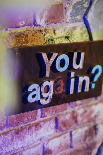 a sign that says you again again on a brick wall, a hologram, unsplash, wooden, in a pub, question marks, aging