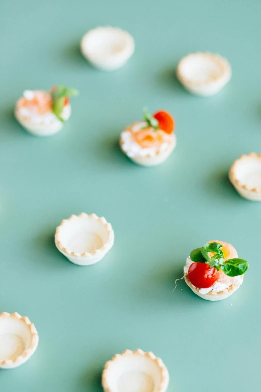 a close up of miniature food on a table, by Nicolette Macnamara, unsplash, teal studio backdrop, lots of mozzarella balls, elegant, oysters