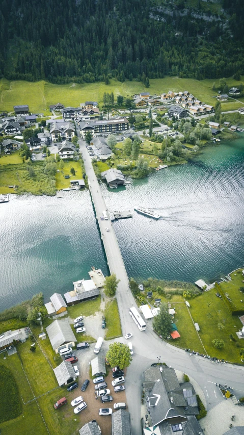 an aerial view of a town next to a body of water, by Roar Kjernstad, pexels contest winner, hurufiyya, bridge, take off, thumbnail, tjalf sparnaay 8 k