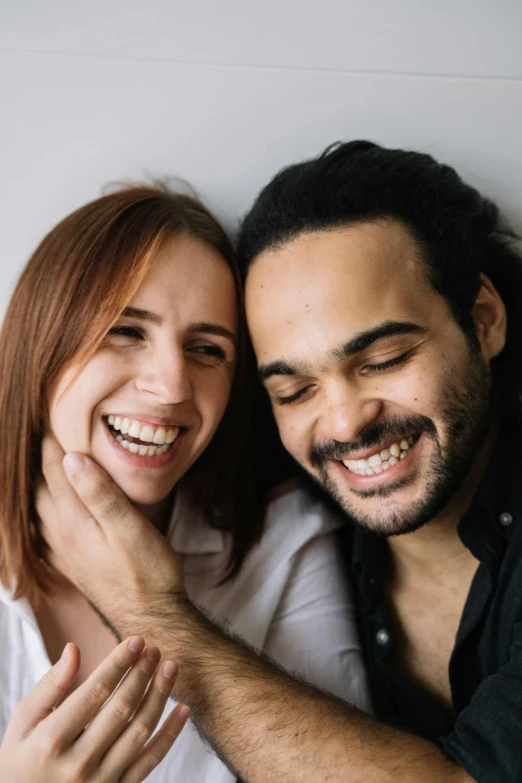 a man and a woman sitting next to each other, trending on pexels, smiling mouth, two men hugging, headshot, mixed race