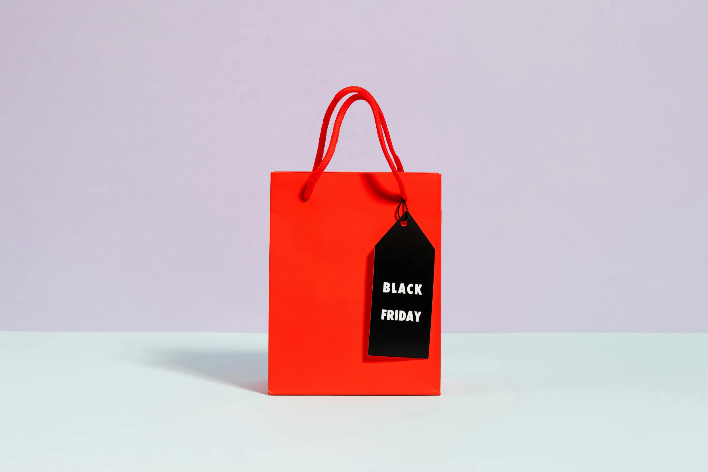 a red shopping bag with a black friday tag on it, by Julia Pishtar, bauhaus, all black matte product, gif, blank, brightly coloured