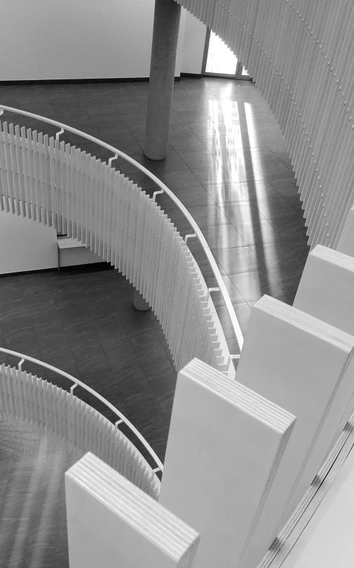 a black and white photo of a spiral staircase, inspired by Ned M. Seidler, renzo piano, architectural model, ffffound, pillars