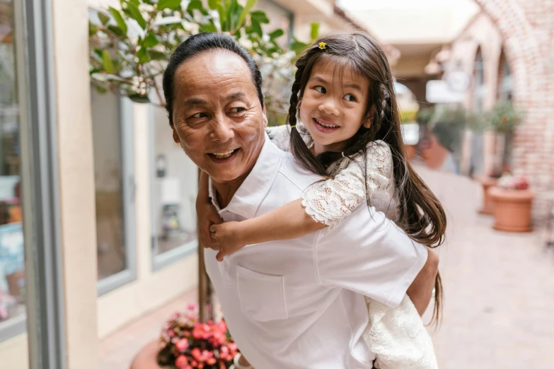 a man carrying a little girl in his arms, pexels contest winner, zeen chin and terada katsuya, avatar image, grandfatherly, 4yr old