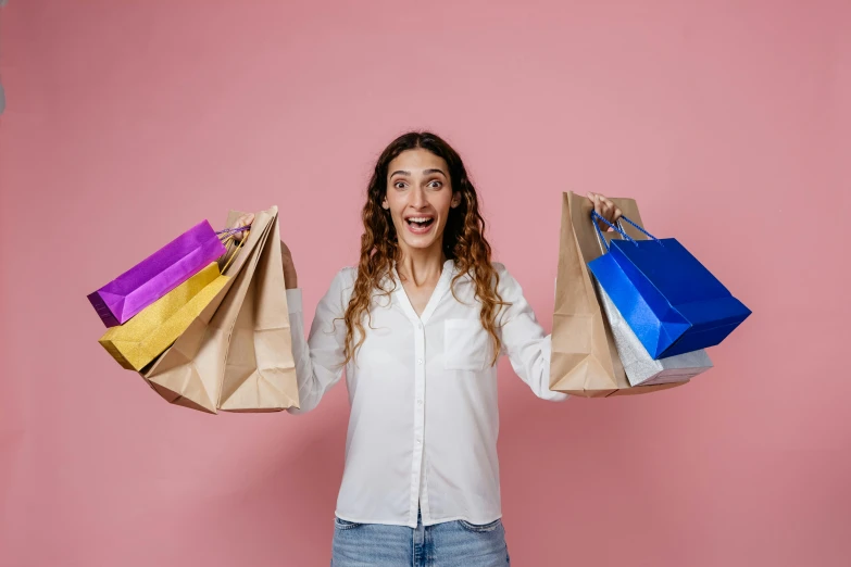 a woman holding shopping bags in her hands, pexels contest winner, all overly excited, avatar image, pink, multi-part
