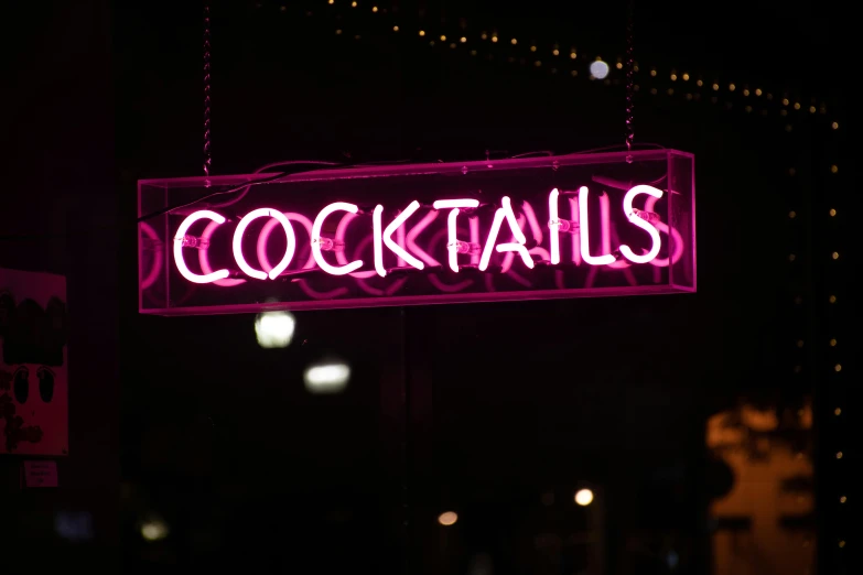 a neon sign hanging from the side of a building, pexels, cocktail in an engraved glass, magenta, nighttime!!, nighthawks
