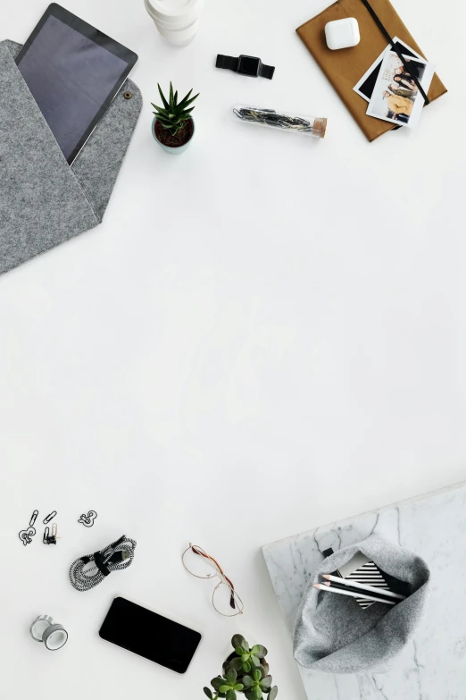 a laptop computer sitting on top of a white table, by Andries Stock, trending on pexels, minimalism, scattered rubbish, grey and silver, cloth accessories, executive industry banner