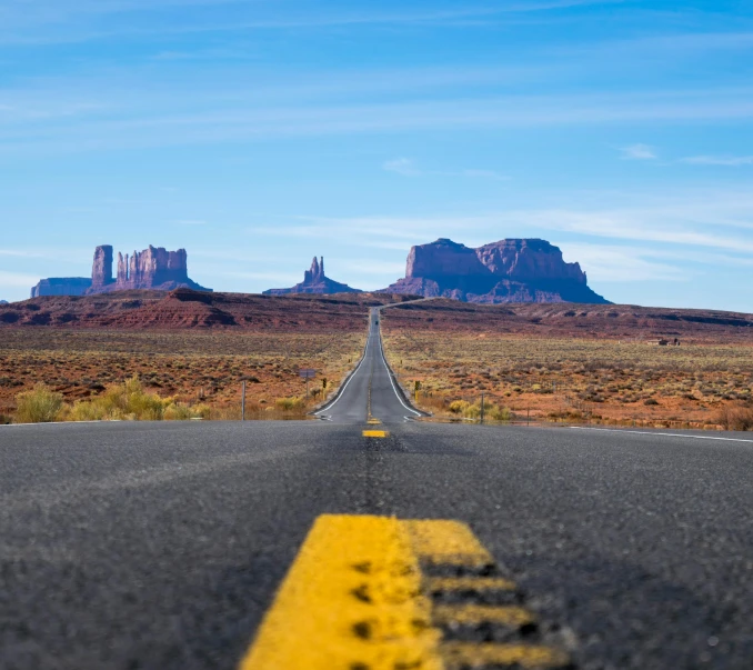 a road in the middle of a desert with mountains in the background, pexels contest winner, style of monument valley, avatar image, square, holiday season