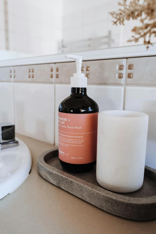 a bath room with a sink and a soap dispenser, by Nicolette Macnamara, unsplash, product label, rust, large tall, bedhead