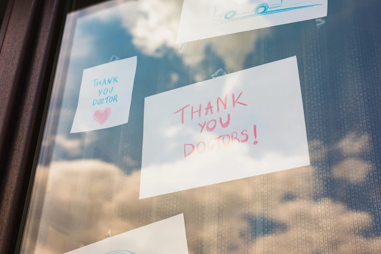 a window with stickers that say thank you do this, pexels, doctor, skies, local heroes, screens