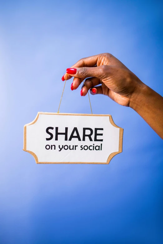 a hand holding a sign that says share on your social, a picture, happening, with a blue background, essence, thumbnail, full body image