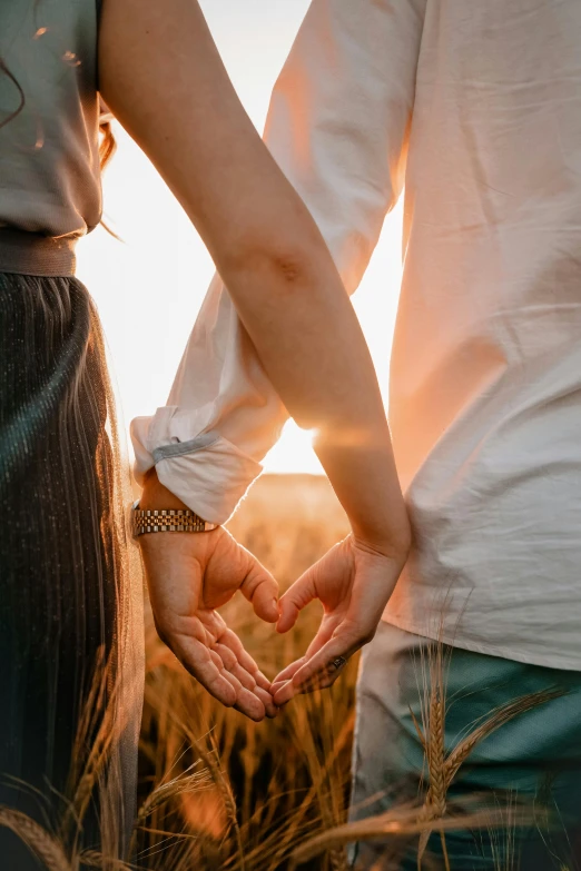 a couple holding hands in a wheat field, trending on pexels, hearts, beautifully lit, woman, paul barson