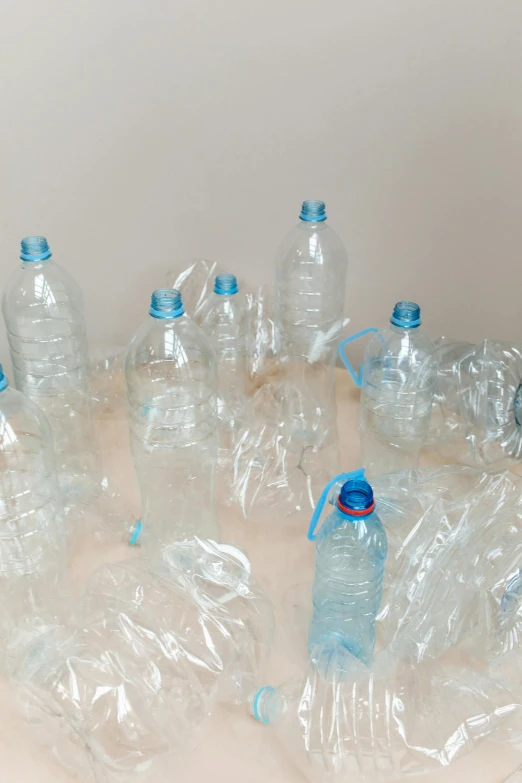 a bunch of plastic bottles sitting on top of a table, by Matija Jama, plasticien, water line surface, unfinished, 8 l, information