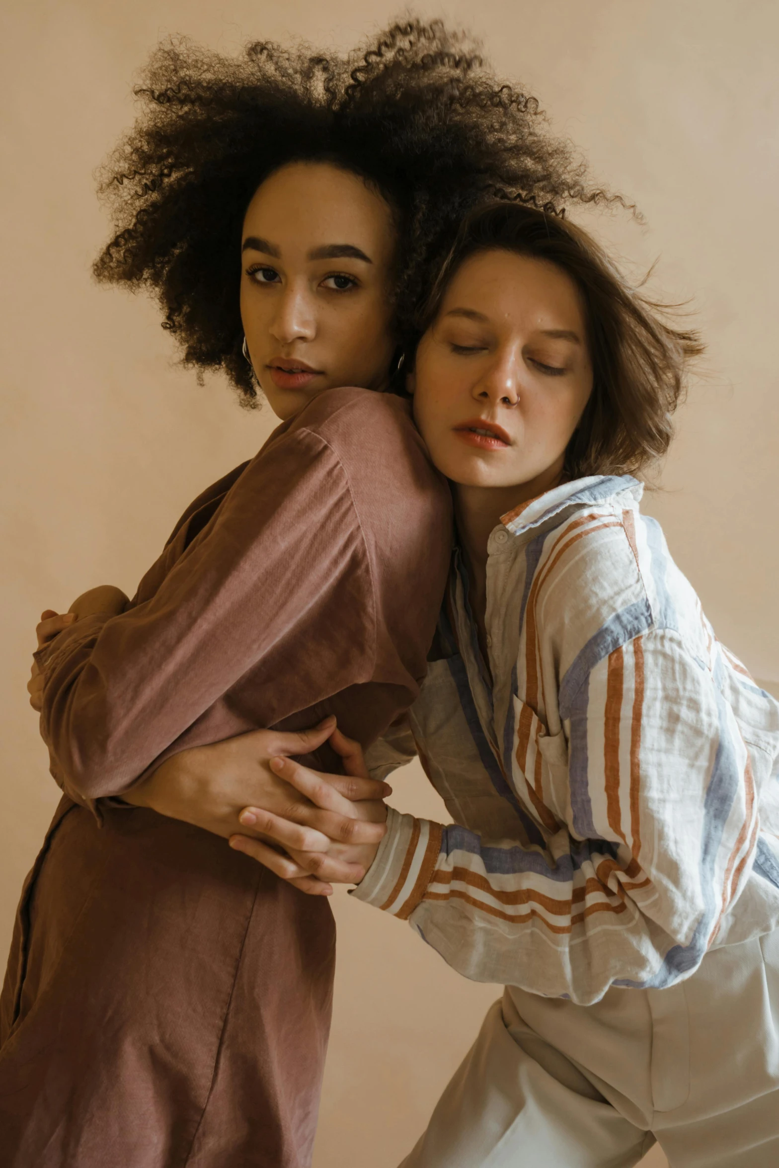 a couple of women standing next to each other, trending on pexels, renaissance, muted browns, cuddling, stripes, linen