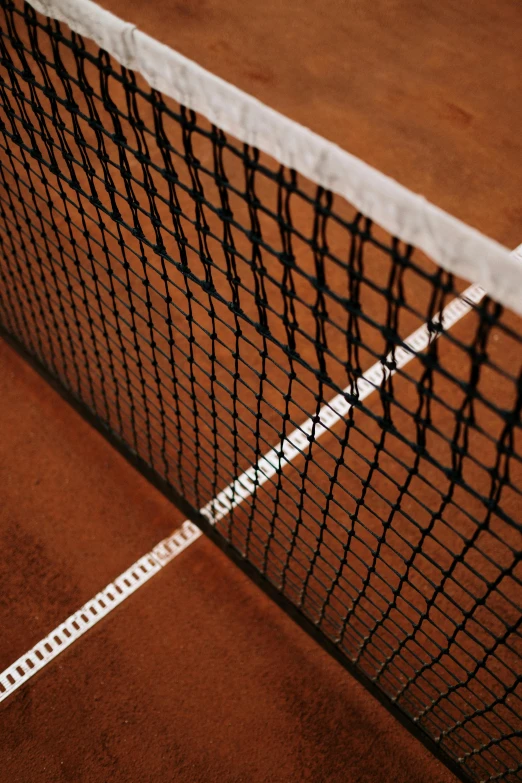 a close up of a tennis net on a tennis court, inspired by Hans Mertens, terracotta, indoor setting, pitch darkness around the post, medium height