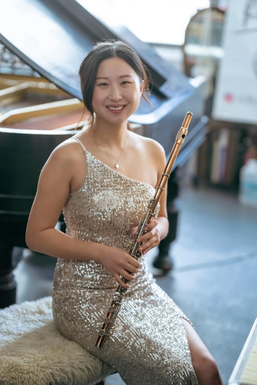 a woman sitting in front of a piano holding a flute, inspired by Zhou Wenjing, close body shot, head and shoulder shot, slightly smiling, modelling