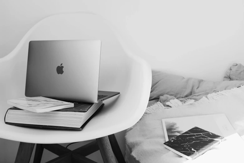 a laptop computer sitting on top of a white chair, a black and white photo, by Emma Andijewska, apple, piled around, influencer, information