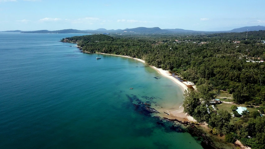 a large body of water next to a beach, by Elizabeth Durack, pexels contest winner, hurufiyya, tamborine, wide aerial shot, tropical location, thawan duchanee