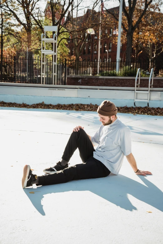a man sitting on the ground on a skateboard, by Carey Morris, freezing, in a square, grayish, ryan dening