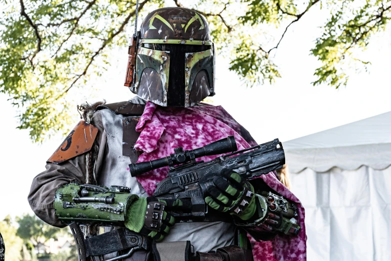 a man in a star wars costume holding a gun, by Tony Szczudlo, unsplash, renaissance fair, doom slayer from doom eternal, boba fett, fully covered in drapes