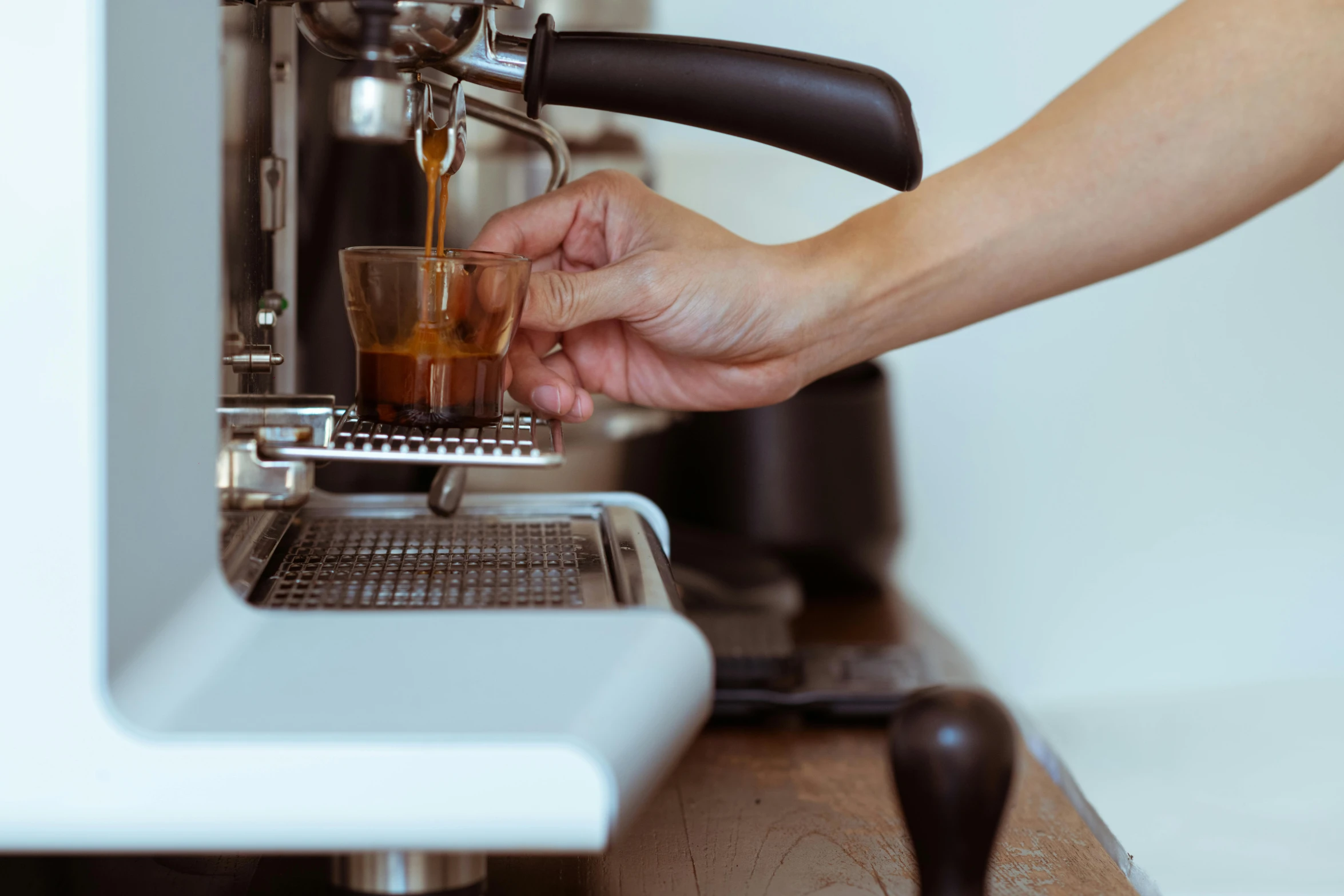 a close up of a person using a coffee machine, by Niko Henrichon, fan favorite, brown, silky smooth, thumbnail