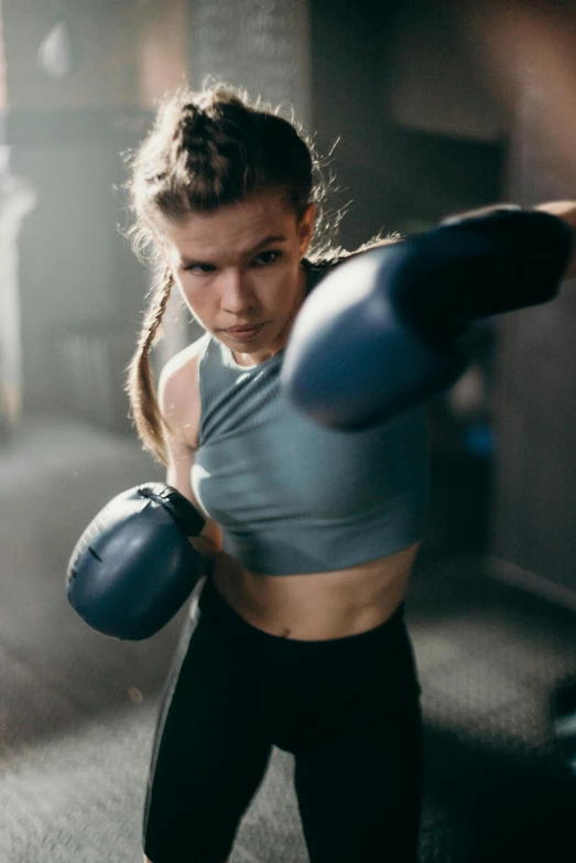 a woman wearing boxing gloves in a gym, a digital rendering, pexels contest winner, sydney sweeney, action sports, promo image, sweat drops