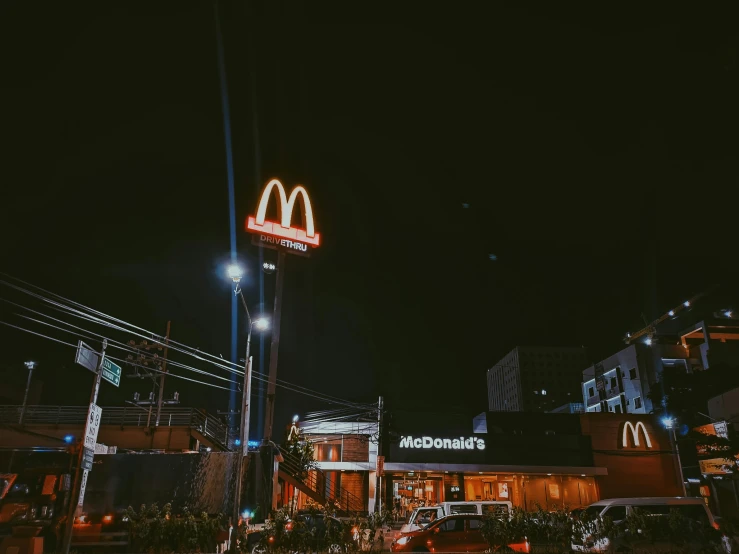 a mcdonald's restaurant lit up at night, pexels contest winner, 🦩🪐🐞👩🏻🦳, normal place with weird feeling, discovered photo, dark and beige atmosphere