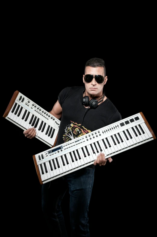 a man holding two keyboards in front of a black background, freddy mamani silvestre facade, 'white background'!!!, promo shoot, rb6s)