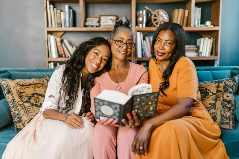 three women sitting on a couch reading a book, a portrait, pexels contest winner, happening, older sister vibes, avatar image, black, portrait of family of three