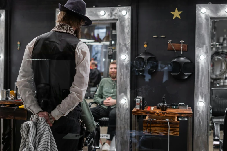 a man standing in front of a mirror in a barber shop, by Julia Pishtar, pexels contest winner, with his back turned, lachlan bailey, long black beard, thumbnail