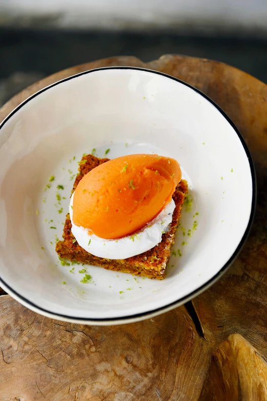 a close up of a plate of food on a table, inspired by Barthélemy Menn, toast, orange body, whipped cream on top, square