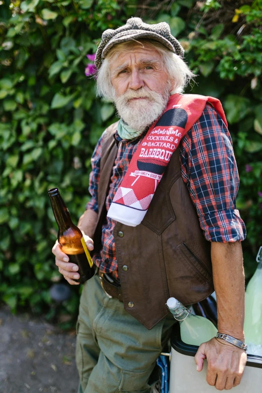 a man standing next to a cooler holding a beer, inspired by John Brown Abercromby, renaissance, wearing a vest top, he‘s wearing a red neckerchief, long white hair and white beard, local conspirologist