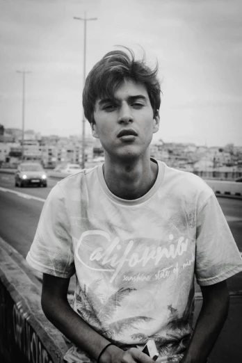 a black and white photo of a young man, unsplash, hyperrealism, teenage jughead jones, washed out colors, slightly tanned, in spain