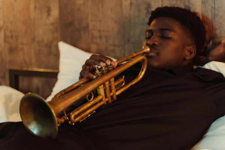 a person laying in a bed with a trumpet, by David Garner, pexels contest winner, godwin akpan, right side profile, sydney mortimer laurence, promotional still