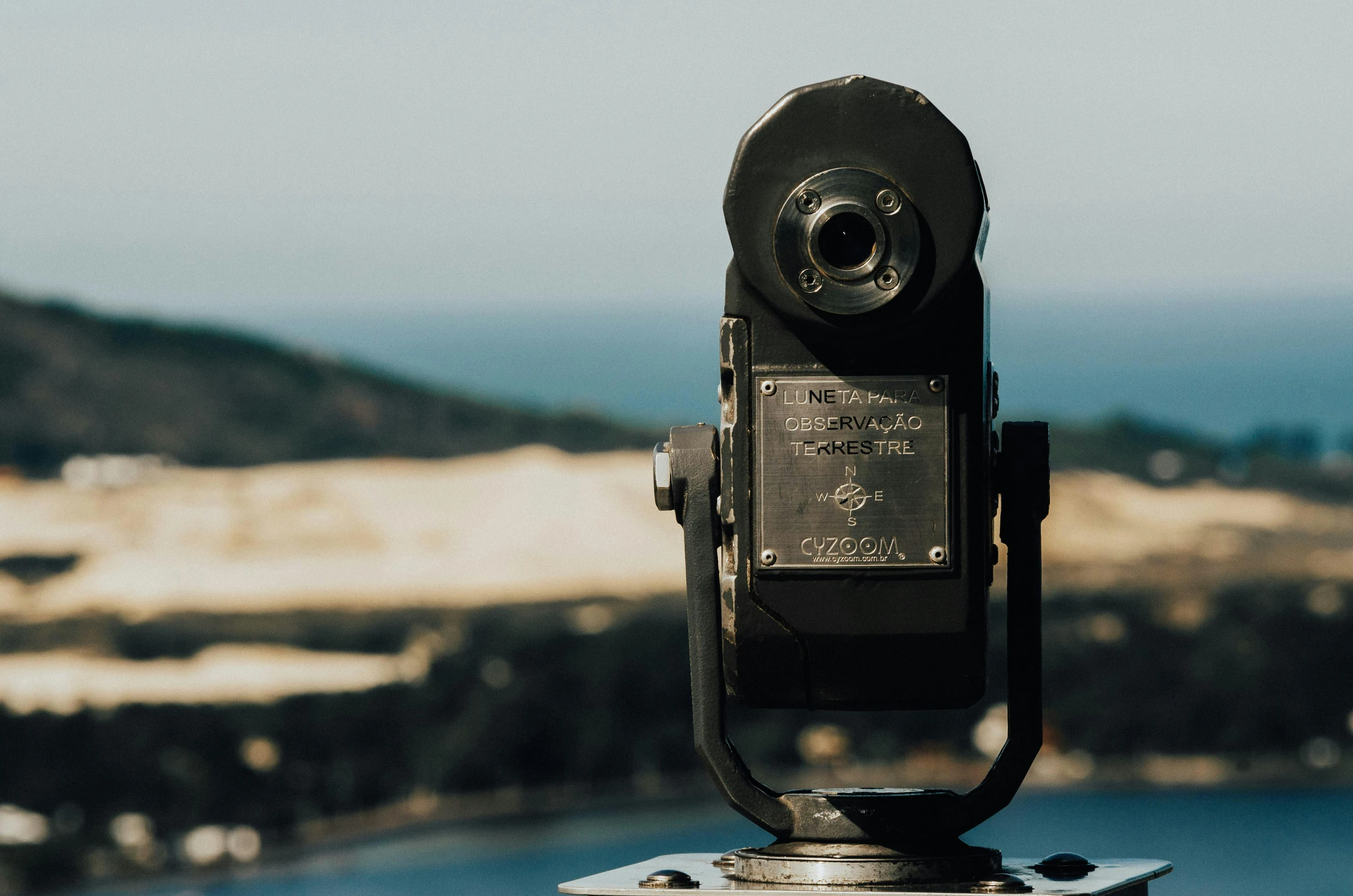 a pair of binoculars sitting on top of a metal pole, a picture, unsplash contest winner, looking out over the sea, vintage camera, zoomed out view, single portrait